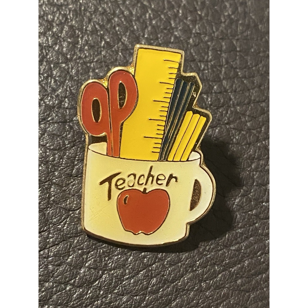 Teacher Cup Filled With Sizzler,Ruler,Pencil,Pen, And An Apple Printed Pin Lapel
